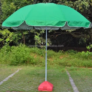 Green advertising parasol with white edge trim on a red plastic water-fill base