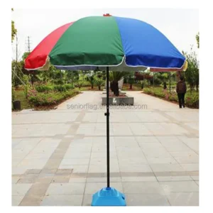 Red, green and blue panelled advertising parasol on a blue plastic water-fill base