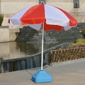Red and white panelled advertising parasol on a blue plastic water-fill base