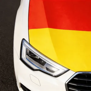 Close-up of a Germany-colored car hood cover on a white car