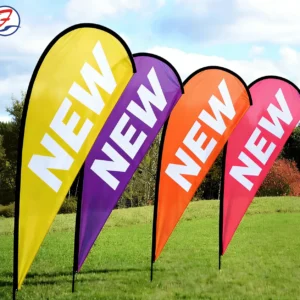 Colorful custom teardrop flags displayed on grass outdoors