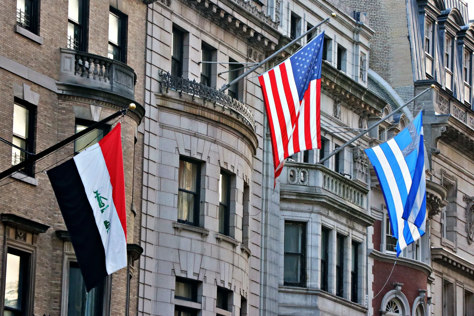 National flags mounted on a building facade