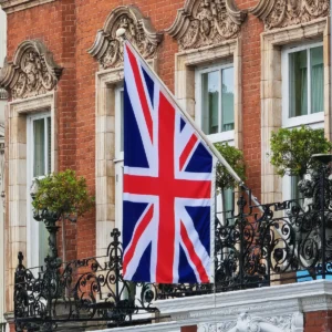 Union Jack wall flag displayed on a building balcony