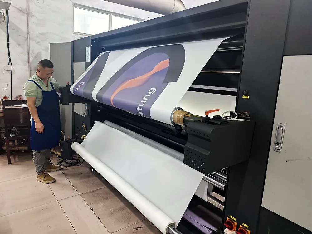 Private Label & OEM Solutions Worker operating a digital printer printing a custom flag design at Senior Flags