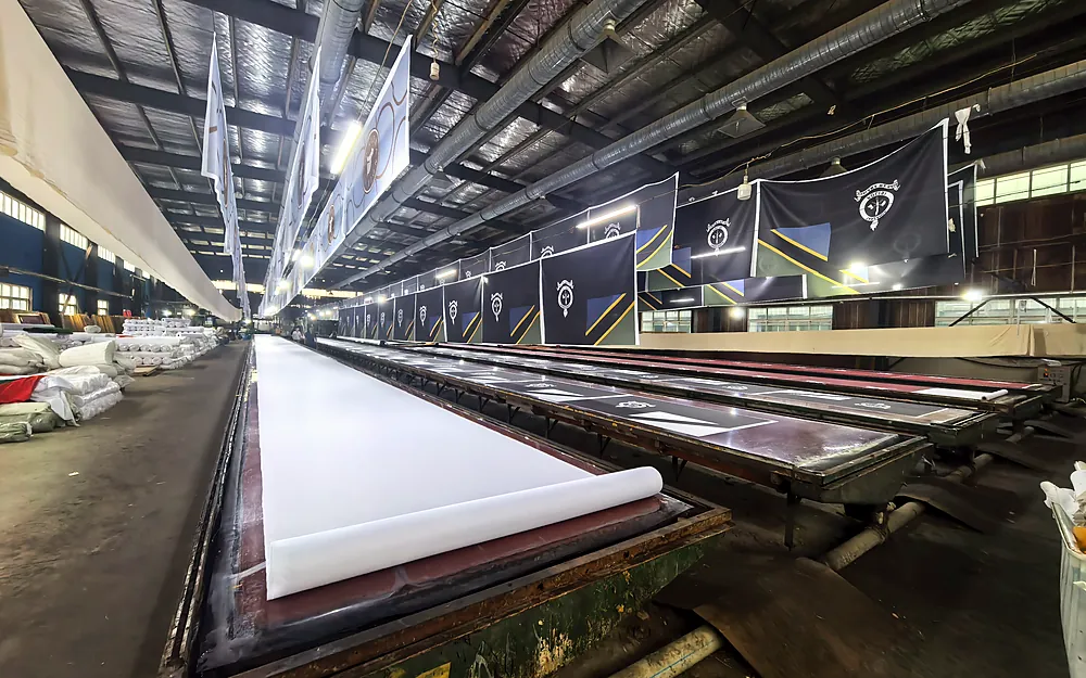 Flag printing production line with long screen printing tables at Senior Flags