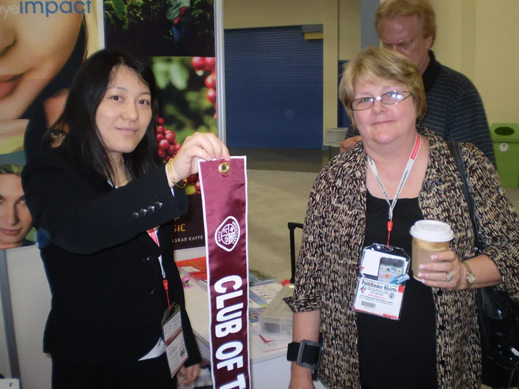 Senior Flags representative with a customer at an exhibition