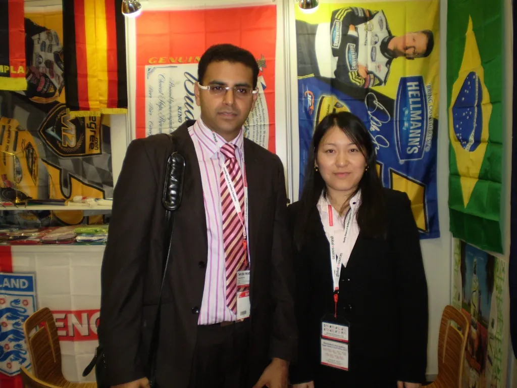 Senior Flags team with a visitor at an exhibition booth