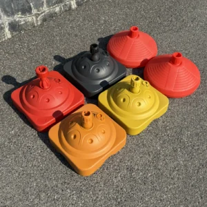 Plastic water-fill umbrella bases in red, black, orange and yellow